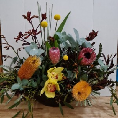 Bloom Boat - Beautiful bright flowers arranged in a boat shaped container. This design simply says, Wow!